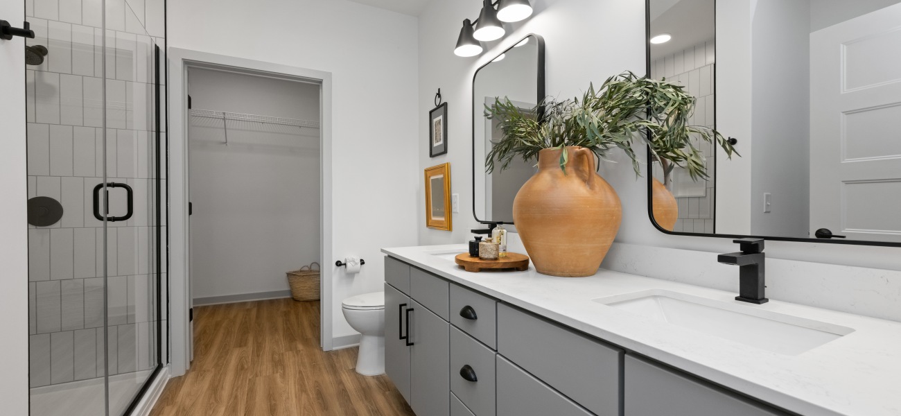 Bathroom with standalone shower, vanity with framed mirror and oversized closet Bathroom with standalone shower, vanity with framed mirror and oversized closet
